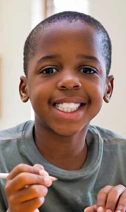 smiling boy receiving behavioral therapy for autism